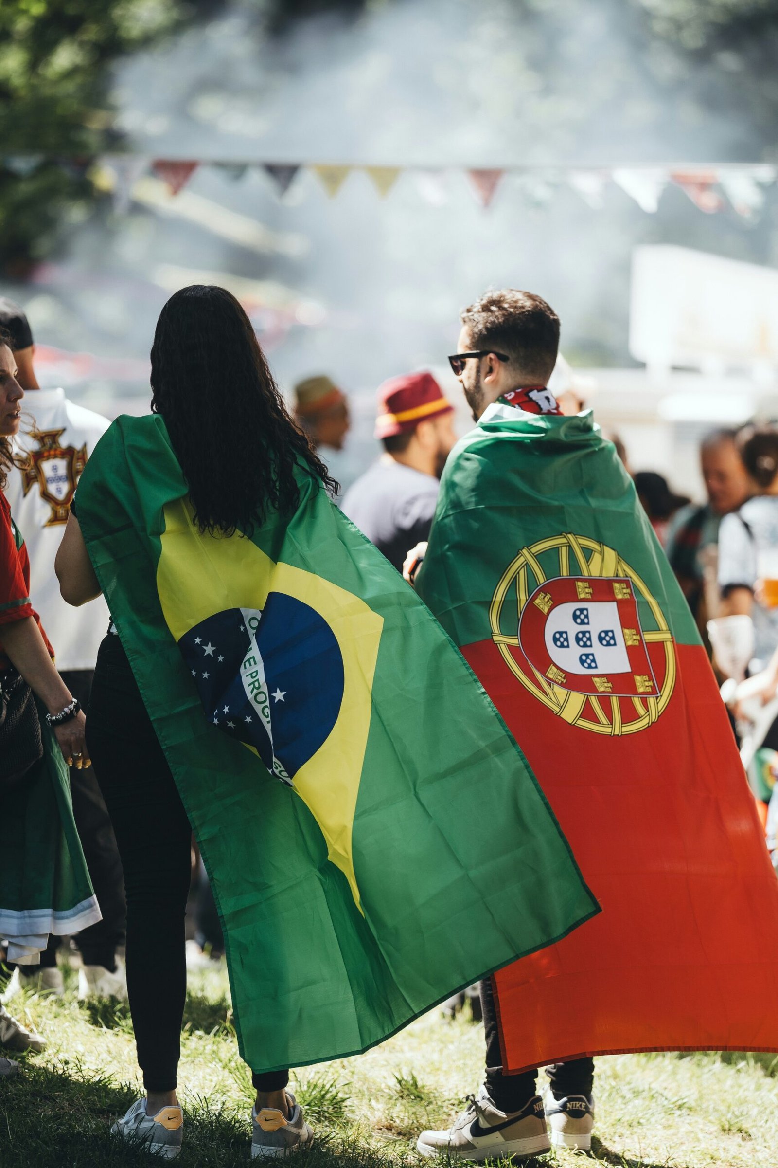 A group of people standing around each other holding flags